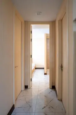 a hallway with two doors and a tile floor at LIV@5 Condominium in Makkasan