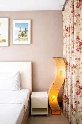 a small bedroom with a bed and a lamp at LIV@5 Condominium in Makkasan