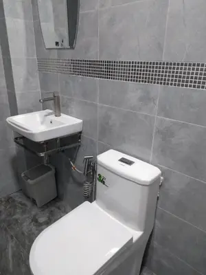 a bathroom with a white toilet and a sink at Sweety Secret Guesthouse in Ban Tambon Bang Khae