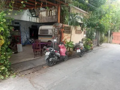 two motorcycles parked in front of a building at Caravan Hotel have TV & Netflix in Bangkok