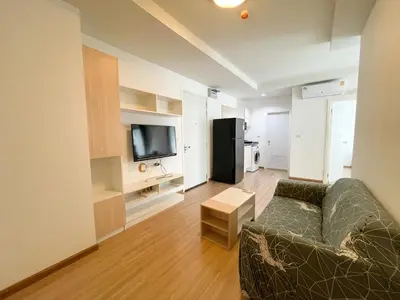 a living room with a couch and a television at 2BR Apartment in Bangkok