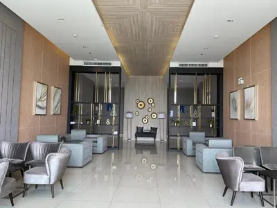 a lobby with couches and chairs in a building at 2BR Apartment in Bangkok