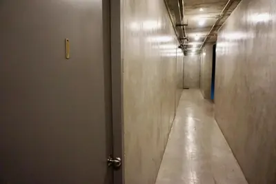 a long hallway with a door and a long corridor at Hash Apartment with unique chill design at Silom Soi 3 in Bangkok