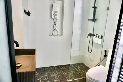 a bathroom with a shower and a toilet at Hash Apartment with unique chill design at Silom Soi 3 in Bangkok