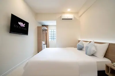 a bedroom with a large white bed with a sign on the wall at สินสิริ นวมินทร์96 in Ban Baen Phichit