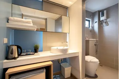 a bathroom with a sink and a toilet and a shower at สินสิริ นวมินทร์96 in Ban Baen Phichit