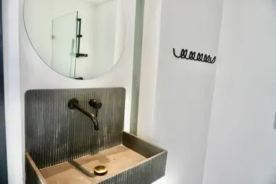 a bathroom with a sink and a mirror at Hip and funky apartment silom Soi 3, with rooftop view in Bangkok