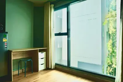 a room with a desk and a large window at Hip and funky apartment silom Soi 3, with rooftop view in Bangkok