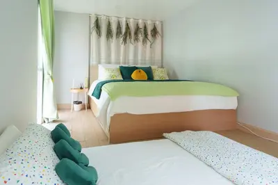 a small bedroom with a bed and a window at t-t-haus in Bangkok