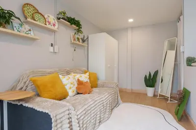 a living room with a couch and a table at t-t-haus in Bangkok