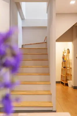 a staircase in a house with wooden steps at t-t-haus in Bangkok