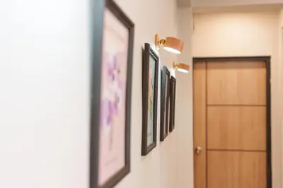 a hallway with pictures on the wall and a door at t-t-haus in Bangkok