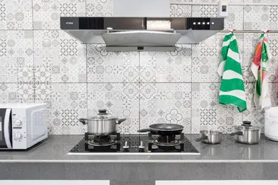 a kitchen with two pots and pans on a stove at MIQ HK16 - 3BR Huai Khwang MRT with Pool Table near Jodd Fair in Ban Zong Katiam