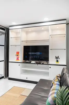 a living room with a couch and a tv at MIQ HK16 - 3BR Huai Khwang MRT with Pool Table near Jodd Fair in Ban Zong Katiam