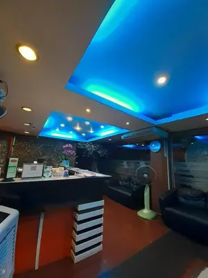 a bar in a room with a blue ceiling at Bangkok Travel Suites Hotel in Nonthaburi