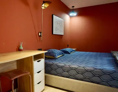 a bedroom with a bed and a desk in it at Silom Soi 3 Hash Apartment hip and funky with rooftop view in Bangkok