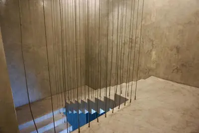 a shower in a room with wooden walls at Silom Soi 3 Hash Apartment hip and funky with rooftop view in Bangkok