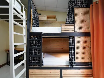 a room with bunk beds in a hostel at EZ Sleep @ Ratchada 19 in Bangkok