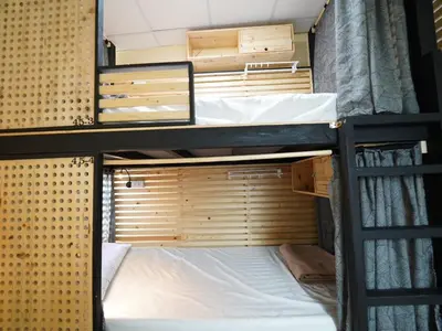 a couple of bunk beds in a room at EZ Sleep @ Ratchada 19 in Bangkok