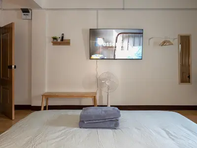 a bedroom with a bed with a fan on it at 206HiddenNest, Local Room with Street Food only 15 min walk to Skytrain in Bangkok