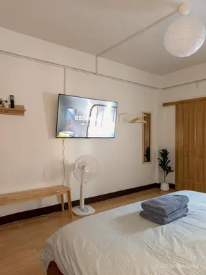 a bedroom with a bed and a tv on the wall at 206HiddenNest, Local Room with Street Food only 15 min walk to Skytrain in Bangkok