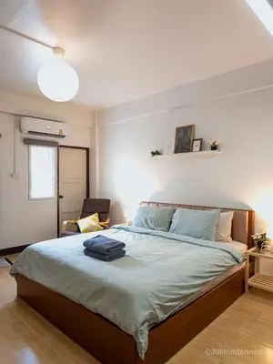 a bedroom with a bed with a suitcase on it at 206HiddenNest, Local Room with Street Food only 15 min walk to Skytrain in Bangkok