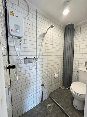 a bathroom with a shower and a toilet at Chubby 9 single room in Bangkok