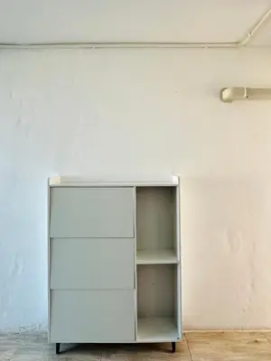 a white cabinet against a white wall at Chubby 9 in Bang O