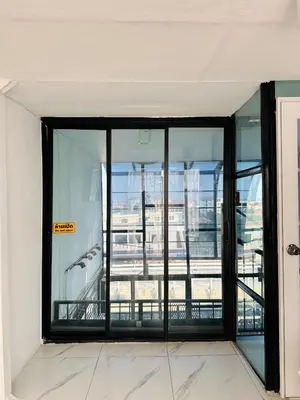 an empty room with glass doors in a building at Chubby 9 in Bang O