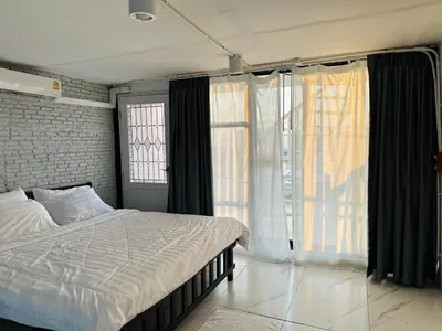 a bedroom with a bed and a large window at Chubby 9 in Bang O