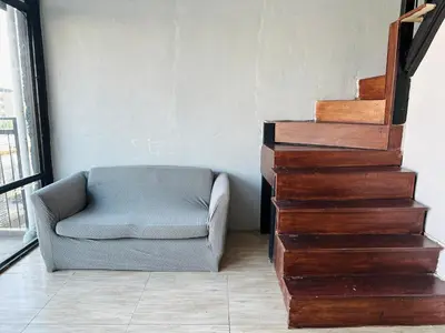a stairway with a chair next to a stair case at Chubby 9 in Bang O