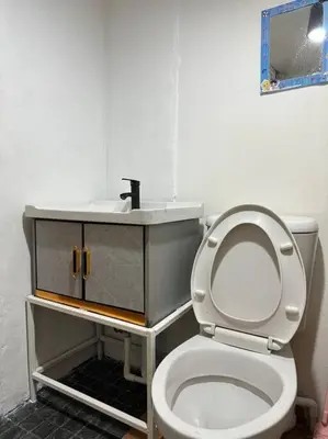 a bathroom with a white toilet and a sink at Chubby 5 Room 5 in Bangkok