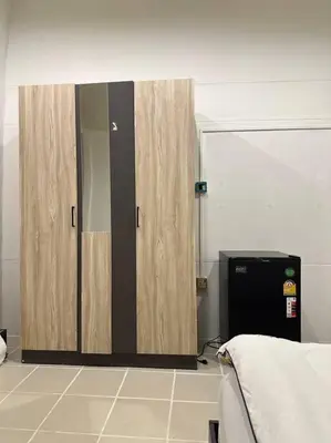 a bedroom with ajar doors in a room at Chubby 5 Room 5 in Bangkok