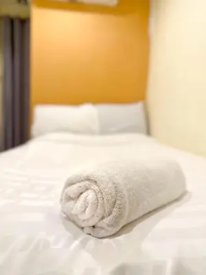a white towel sitting on top of a bed at Chubby 5 in Bang O