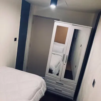 a bedroom with a mirror next to a bed at Chubby 5 in Bang O