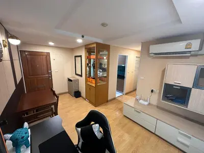 a living room with a couch and a television at 2bd Apartment near icon Siam close to Everything in Bangkok