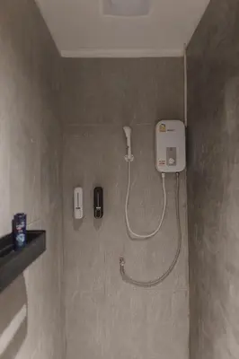 a shower in a bathroom with a phone on the wall at Private house 4bedrooms at Thonglor 4bath5toilet 10people in Bangkok