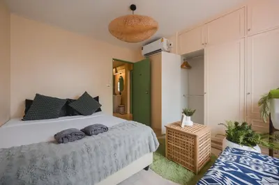 a bedroom with a white bed and a green wall at Private house 4bedrooms at Thonglor 4bath5toilet 10people in Bangkok