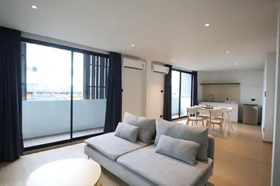 a living room with a couch and a table at Casa del Toro in Bangkok