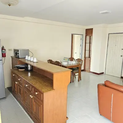 a kitchen with a counter and a table with chairs at Omni Suites 2Bedroom in Bangkok