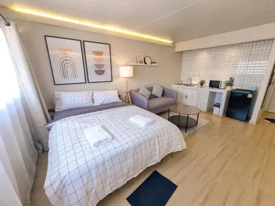 a bedroom with a bed and a couch in it at Better Room ห้องพักรายวัน เมืองทองธานี C4 in Ban Bang Phang