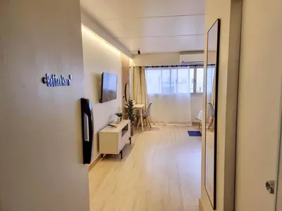 a hallway of an office with a desk and a television at Better Room ห้องพักรายวัน เมืองทองธานี C4 in Ban Bang Phang