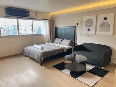 a small bedroom with a bed and a couch at Better Room ห้องพักรายวัน เมืองทองธานี C2 in Nonthaburi