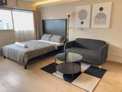 a living room with a bed and a couch at Better Room ห้องพักรายวัน เมืองทองธานี C2 in Nonthaburi