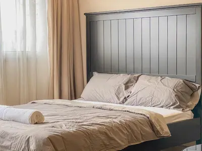 a bed with a headboard and pillows on it at Better Room ห้องพักรายวัน เมืองทองธานี C2 in Nonthaburi