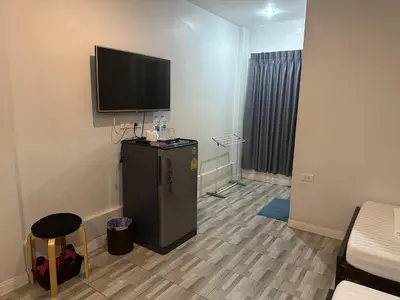 a room with a flat screen tv on the wall at Baanfahsai in Makkasan