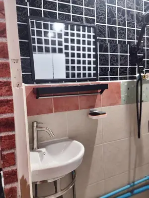 a bathroom with a sink and a mirror at 108 Quiet and nice fan apartment with full amenities free Wi-Fi in Bangkok