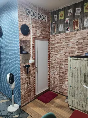 a room with a door and a brick wall at 108 Quiet and nice fan apartment with full amenities free Wi-Fi in Bangkok