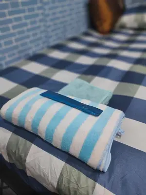 a towel sitting on top of a bed at 108 Quiet and nice fan apartment with full amenities free Wi-Fi in Bangkok
