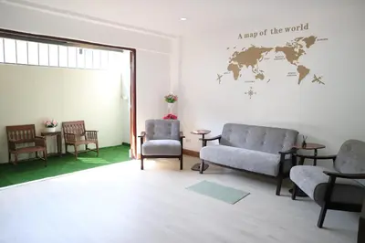 a waiting room with chairs and a map of the world on the wall at Happyhouse Laksi station (PK14) in Lak Si